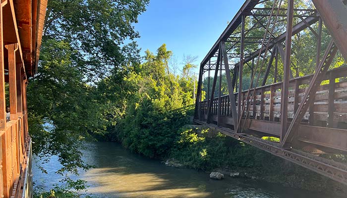 The pedestrian bridge of the Root River State Trail in Lanesboro, MN is locate directly beside Juniper's Restaurant